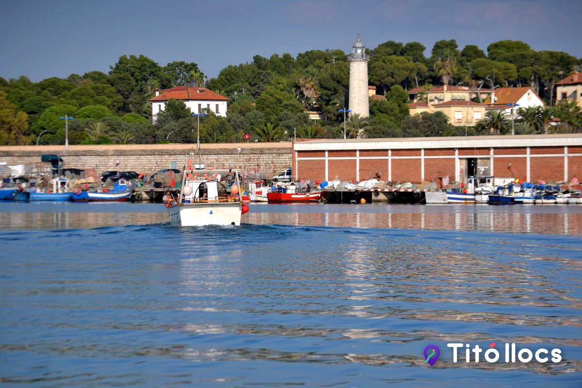 La bocana del port de Vilanova amb els vaixets de pesca i el far al fons